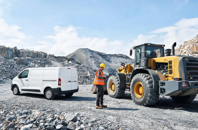 Field service engineer inspecting loader on quarry site