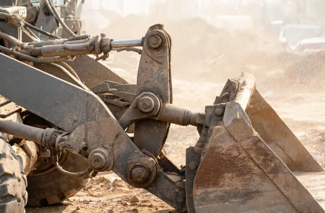 Wheel loader Z-bar linkage and bucket pin close-up