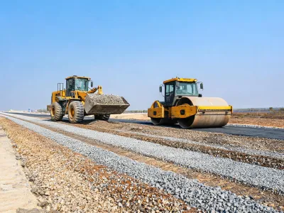 Highway base course with loader and roller